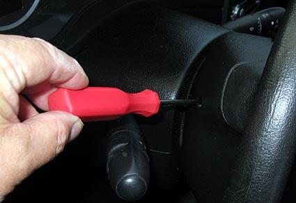 Push with a screwdriver